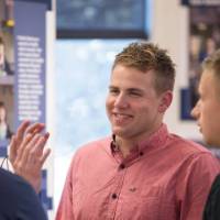 Students laugh during a conversation